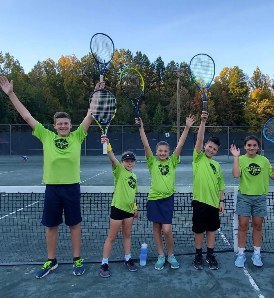 a group of kids excited to learn how to play tennis